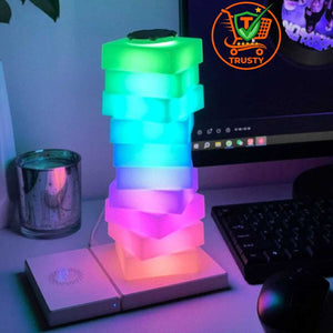 Colourful LED lamp on a desk with a computer monitor in the background