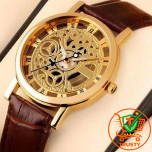 Gold mechanical watch with brown leather strap on a gray background